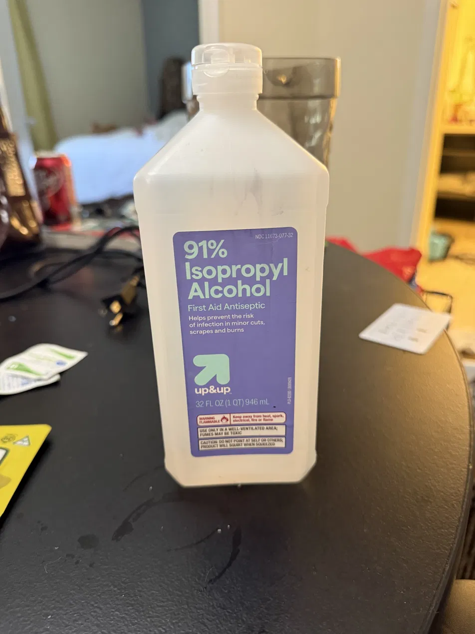Bottle of 91% isopropyl alcohol on a table